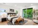 Bright main bedroom with a sliding glass door, stylish decor, and a leather bench at 1518 S Columbine St, Denver, CO 80210