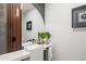 Stylish powder room featuring a floating vanity, modern fixtures, and elegant wood accent wall at 1518 S Columbine St, Denver, CO 80210