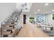 Contemporary staircase with glass railings and wooden steps leading to the upper level living space at 1518 S Columbine St, Denver, CO 80210