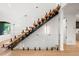 Elegant floating staircase with glass and wood elements, adding architectural interest to the space at 1518 S Columbine St, Denver, CO 80210