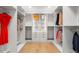 Spacious walk-in closet with custom shelving, ample storage, and hardwood floors at 1518 S Columbine St, Denver, CO 80210