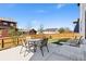 Private backyard featuring a concrete patio, mature landscaping, and full fencing at 6739 Blue Spruce St, Frederick, CO 80530
