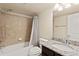 Well-lit bathroom features a shower-tub combo, granite countertop, and neutral finishes at 6739 Blue Spruce St, Frederick, CO 80530