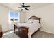 Bedroom featuring a ceiling fan, plush carpet, and a lovely view at 6739 Blue Spruce St, Frederick, CO 80530