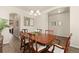 A spacious dining room with wooden table and chairs, bathed in natural light at 6739 Blue Spruce St, Frederick, CO 80530