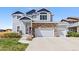 Charming two-story home with blue siding, stone accents, and a well-manicured front yard at 6739 Blue Spruce St, Frederick, CO 80530