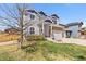 Two-story home with blue siding, stone accents, manicured front yard and mature tree at 6739 Blue Spruce St, Frederick, CO 80530