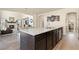 Spacious kitchen island with a granite countertop, stainless steel appliances, open to living area at 6739 Blue Spruce St, Frederick, CO 80530