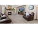 Comfortable living room with a fireplace, tv, and plush seating at 6739 Blue Spruce St, Frederick, CO 80530