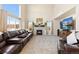 Cozy living room with a fireplace, large windows, and plush seating at 6739 Blue Spruce St, Frederick, CO 80530