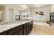 Bathroom with double sinks, granite counters, tile flooring, soaking tub, and walk-in shower at 6739 Blue Spruce St, Frederick, CO 80530