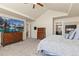 Spacious main bedroom featuring a fireplace, television, walk-in closet, and ensuite bathroom at 6739 Blue Spruce St, Frederick, CO 80530