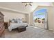 Bright main bedroom featuring a ceiling fan, large window with neighborhood views, and plush carpet at 6739 Blue Spruce St, Frederick, CO 80530