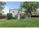 Lush backyard featuring a well-maintained lawn, mature trees, and a pergola-covered patio at 3458 S Norfolk Way, Aurora, CO 80013