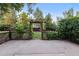 Backyard patio with an archway covered in vines and greenery at 3458 S Norfolk Way, Aurora, CO 80013