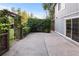 Patio area next to the house with privacy landscaping and a wooden pergola at 3458 S Norfolk Way, Aurora, CO 80013