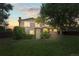 Spacious backyard featuring lush lawn, mature trees, and a charming trellis-covered patio area at 3458 S Norfolk Way, Aurora, CO 80013