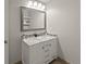 Bright bathroom features a double sink vanity with marble countertop and framed mirror at 3458 S Norfolk Way, Aurora, CO 80013