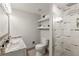Updated bathroom featuring a double sink vanity, marble countertops, and a glass-enclosed shower at 3458 S Norfolk Way, Aurora, CO 80013
