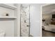 Modern bathroom featuring updated shower stall with glass door and rainfall shower head at 3458 S Norfolk Way, Aurora, CO 80013