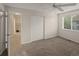 Spacious bedroom featuring neutral carpeting, closet with double doors, and ceiling fan at 3458 S Norfolk Way, Aurora, CO 80013