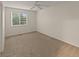 Bedroom features neutral carpeting, ceiling fan, and a window with natural light at 3458 S Norfolk Way, Aurora, CO 80013