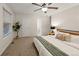 Bedroom with a ceiling fan, carpet flooring, and access to an ensuite bathroom at 3458 S Norfolk Way, Aurora, CO 80013