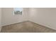Cozy bedroom featuring neutral carpeting and a bright window for natural light at 3458 S Norfolk Way, Aurora, CO 80013
