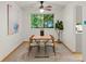 Dining room with wooden table, chairs, and large picture window at 3458 S Norfolk Way, Aurora, CO 80013