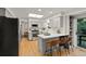 Modern kitchen with stainless steel appliances, light gray cabinets, and an eat-in island at 3458 S Norfolk Way, Aurora, CO 80013