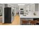 Modern kitchen with stainless steel appliances, gray cabinets, quartz countertops, and breakfast bar at 3458 S Norfolk Way, Aurora, CO 80013