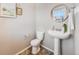 Clean bathroom with pedestal sink and toilet at 6044 Point Rider Cir, Castle Rock, CO 80104