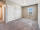 Spacious bedroom with carpeted floor and a large window at 6044 Point Rider Cir, Castle Rock, CO 80104