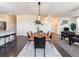 Open concept dining area with wood table and view of kitchen at 6044 Point Rider Cir, Castle Rock, CO 80104