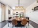 Modern dining area with a wood table and view into kitchen at 6044 Point Rider Cir, Castle Rock, CO 80104