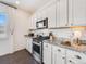 White shaker cabinets, granite countertops, and stainless steel appliances at 6044 Point Rider Cir, Castle Rock, CO 80104