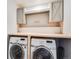 Laundry room with Samsung washer and dryer, and cabinets at 6044 Point Rider Cir, Castle Rock, CO 80104