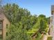 Scenic backyard with mature trees and view of surrounding landscape from deck at 625 Kendall Way, Lakewood, CO 80214