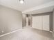 Finished basement with carpet, white closet doors, and light grey walls at 625 Kendall Way, Lakewood, CO 80214