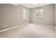 Basement room with carpet, natural light from two windows, and neutral walls at 625 Kendall Way, Lakewood, CO 80214