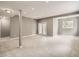 Finished basement features carpet, recessed lighting, and access to the outside through glass doors at 625 Kendall Way, Lakewood, CO 80214