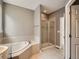 Bathroom featuring a soaking tub and separate shower at 625 Kendall Way, Lakewood, CO 80214
