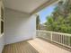 Inviting outdoor deck with wood flooring and white railing overlooks lush greenery at 625 Kendall Way, Lakewood, CO 80214