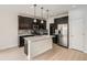 Spacious kitchen with stainless steel appliances, an island with seating, and dark wood cabinets at 625 Kendall Way, Lakewood, CO 80214