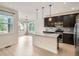 Modern kitchen with granite countertops, stainless steel appliances, and a large island with pendant lighting at 625 Kendall Way, Lakewood, CO 80214