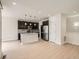 An open kitchen with stainless steel appliances, gray backsplash, and dark cabinets with an island at 625 Kendall Way, Lakewood, CO 80214