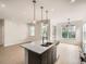 Modern kitchen boasts stainless appliances, granite countertops, and stylish pendant lighting at 625 Kendall Way, Lakewood, CO 80214