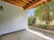 Cozy covered patio with exposed wood ceiling and view of mature trees at 625 Kendall Way, Lakewood, CO 80214