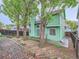 Expansive backyard showcasing the home's exterior and a well-maintained yard with mature trees at 12025 Monaco Dr, Brighton, CO 80602