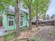 Lush green backyard featuring a patio and mature trees creating a private outdoor space at 12025 Monaco Dr, Brighton, CO 80602
